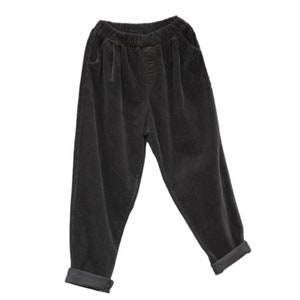 May include: Black corduroy pants with a wide leg and a cuffed hem.