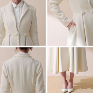 May include: A white wool coat with a fitted bodice and a flared skirt. The coat has a classic collar, long sleeves, and a button closure. The coat is shown on a model wearing white shoes.