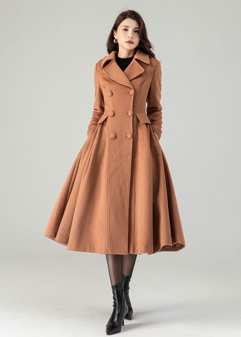 May include: A long, brown, double-breasted coat with a flared skirt. The coat has a classic collar and two pockets.