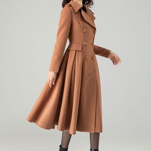 May include: A brown double-breasted wool coat with a flared skirt. The coat has a classic collar and a fitted waist.