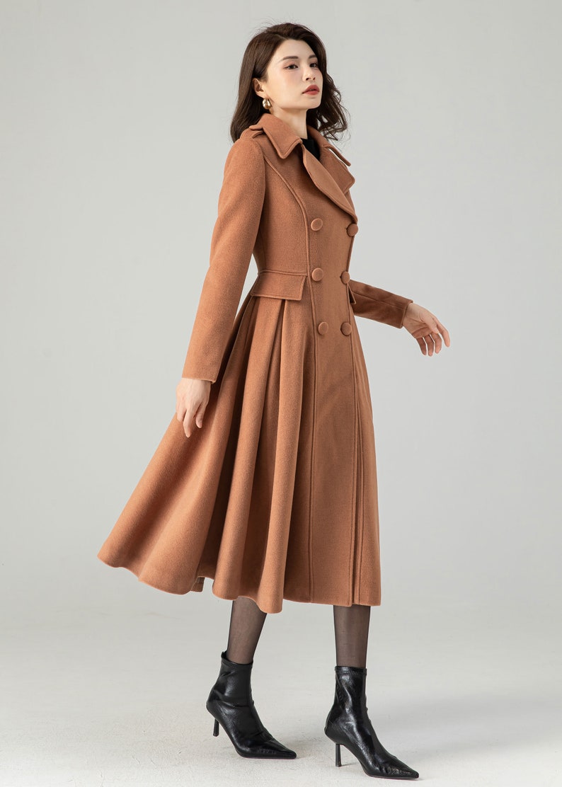 May include: A brown double-breasted wool coat with a flared skirt. The coat has a classic collar and a fitted waist.