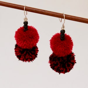 Dangling double pompom earrings, red and black, with lava beads