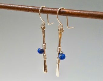 Long forged dangling silver earrings with denim lapis gem balls.