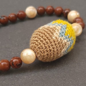 Necklace with hand crocheted bead, botanically dyed yarn, mother of Pearl and mahogany jasper beads