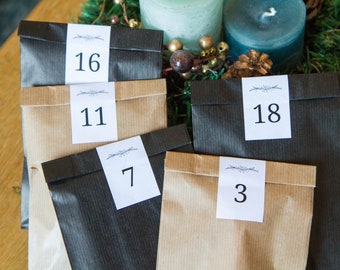 Brown or black kraft bags with labels for the Advent Calendar