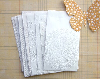 White embossed paper gift bags, set of 15, various designs