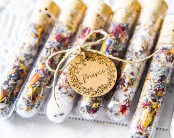 Test tubes filled with Epsom salt and dried flowers.