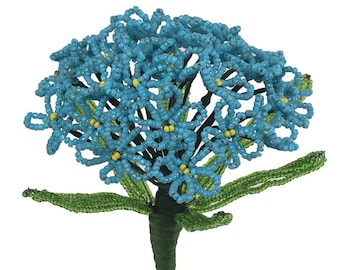 May include: A blue beaded flower bouquet with green leaves and a brown stem.
