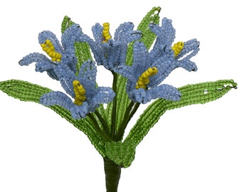 May include: A bouquet of blue and yellow beaded flowers with green beaded leaves.
