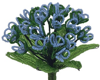 May include: A blue and green beaded flower with a long stem. The flower is made of small beads and is a delicate and intricate piece of craft.