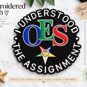 May include: A circular black embroidered patch featuring the text I UNDERSTOOD THE ASSIGNMENT in white, with the letters OES in blue, green, and red. A five-pointed star emblem is centred below the letters. The patch measures 7.62 cm.