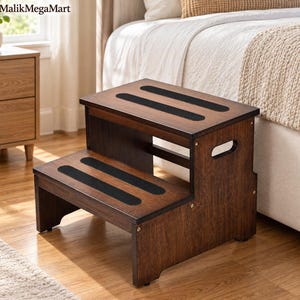 May include: A two-step wooden stool with a dark brown finish. Each step features two horizontal black non-slip adhesive strips. The side panels include integrated cutout handles for portability. The stool has a sturdy construction with visible screws.