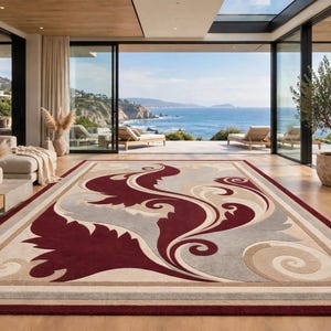 May include: A rectangular area rug featuring a bold, large-scale swirling floral pattern in deep burgundy, soft beige, and light gray. The design is framed by a solid burgundy border, with a neutral beige background and symmetrical scrollwork.