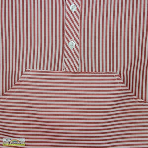 May include: Close-up of a red and white striped shirt. The shirt features a pocket and a button-down placket with two white buttons. The stripes are vertical on the main body and horizontal on the pocket.