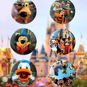 May include: Six circular pin-back buttons featuring various Disney characters including Pluto, Mickey Mouse, Minnie Mouse, Donald Duck, and Goofy in different settings, with some showing the characters in front of a large castle structure.