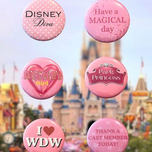 May include: A set of six circular pink buttons featuring various designs and text: Disney Diva, Have a MAGICAL day, Disney Girl with a heart, Park Princess with a crown, I heart WDW, and THANK A CAST MEMBER TODAY with star accents.