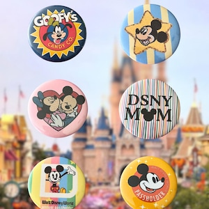 May include: Six circular pinback buttons featuring Disney characters and themes. Designs include Goofy's Candy Co, Mickey Mouse on a star, Minnie and Mickey kissing, DSNY MOM text, a Walt Disney World annual passholder logo, and a Mickey Mouse passholder badge.
