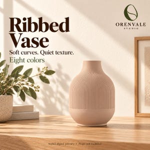 May include: A light pink vase with a vertical ribbed texture on the upper portion and a smooth base. The image includes the text: Ribbed Vase, Soft curves. Quiet texture. Eight colors, and the Orenvale Studio logo.