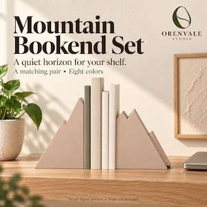 May include: A pair of beige mountain-shaped bookends holding three books upright. The text Mountain Bookend Set, A quiet horizon for your shelf, A matching pair, Eight colors, and Orenvale Studio is visible above the bookends.