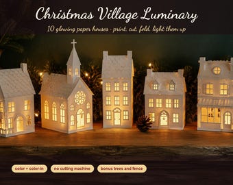 May include: A set of ten white paper houses for a Christmas village luminary display. The structures feature cut-out windows and doors that glow from internal light. Text includes: Christmas Village Luminary, 10 glowing paper houses, print, cut, fold, light them up, color + color-in, no cutting machine, bonus trees and fence.