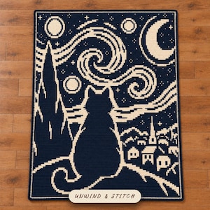 May include: A rectangular crochet blanket featuring a dark navy blue and cream pixelated design of a cat sitting and looking at a swirling night sky with a crescent moon, stars, and a small village. The text UNWIND & STITCH is printed at the bottom.