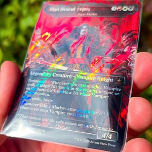 May include: A rectangular trading card featuring a red and black illustration of a vampire knight. The text reads Vlad Dracul Tepes, Edgar Markov, Legendary Creature - Vampire Knight, and includes game rules, a flavour quote, and 4/4 at the bottom.