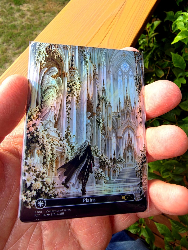 May include: A rectangular trading card featuring a detailed illustration of a figure in a dark cloak walking through a white gothic cathedral with angel statues and floral arrangements. The bottom black border displays the text Plains, P 001 Vampyr Land Series, and PXY-EN TESLA XIII.