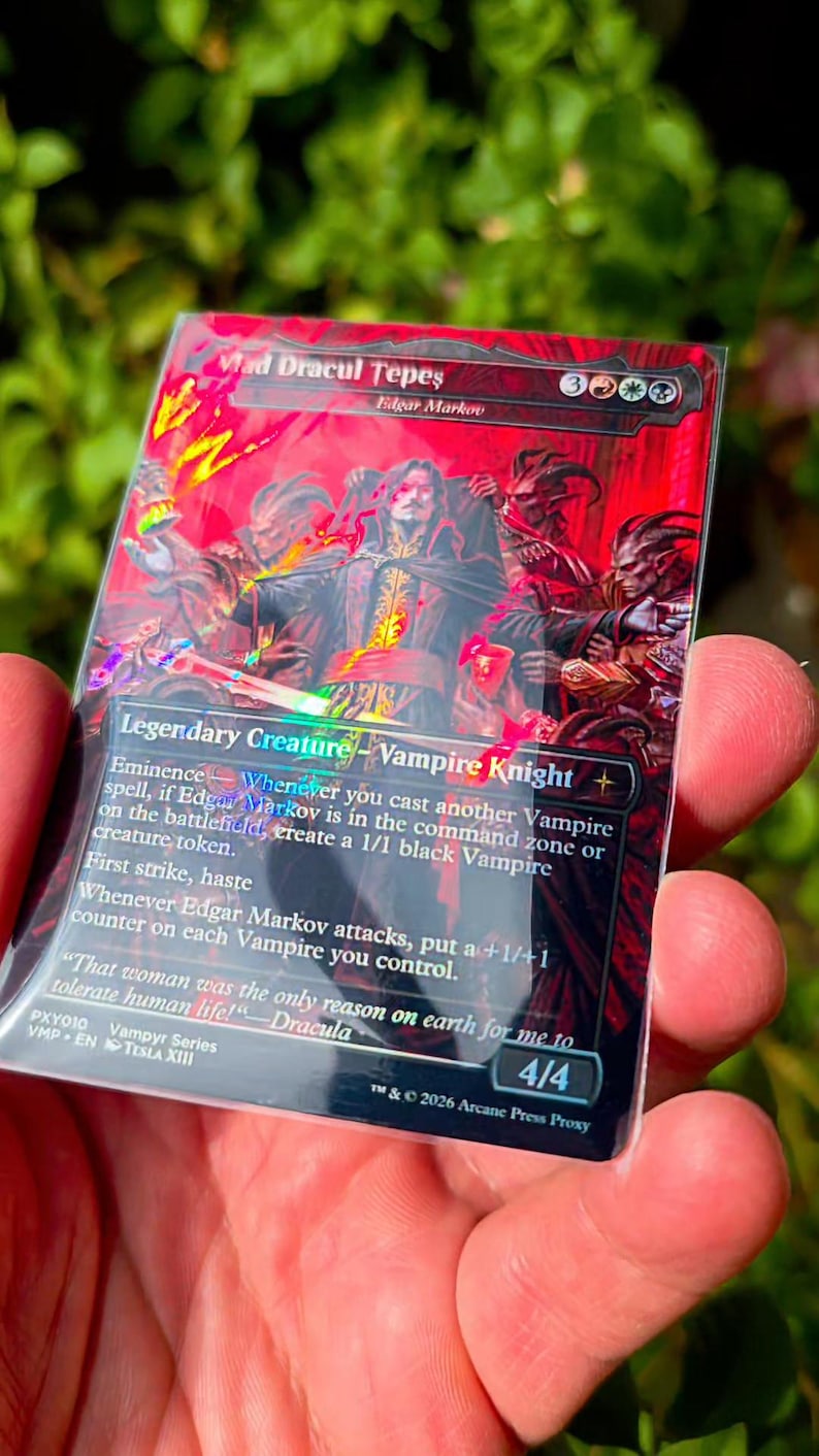 May include: A rectangular trading card featuring a red and black illustration of a vampire knight titled Vlad Dracul Tepes. The card displays game text, a 4/4 power and toughness rating, and the text 2026 Arcane Press Proxy at the bottom.