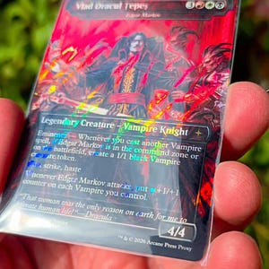 May include: A rectangular trading card featuring a red-toned illustration of a vampire character titled Vlad Dracul Tepes. The card text includes Legendary Creature, Vampire Knight, and the quote That woman was the only reason on earth for me to tolerate human life!—Dracula.