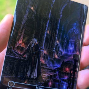 May include: A rectangular trading card titled Swamp, featuring a dark, gothic interior with stone arches, chains, and candles. A long-haired figure in a black and white coat stands beside a stone sarcophagus. The card includes text P 005, Vampyr Land Series, and PXY-EN TESLA XIII.