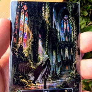May include: A rectangular trading card featuring a dark, gothic cathedral interior overgrown with vines and illuminated by colorful stained glass windows. A figure with long white hair and a dark cloak stands in the center. Text reads Forest, P 003, Vampyr Land Series, PXY-EN, TESLA XIII.