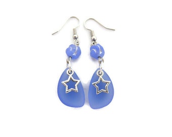 Star Charm Earrings against Blue Beach Glass