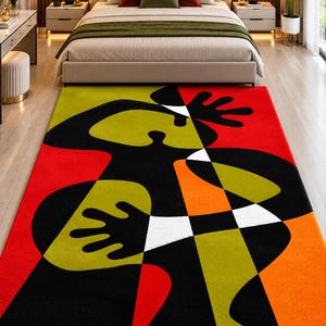 May include: A rectangular area rug featuring a bold, abstract graphic design with large, interlocking shapes in vibrant red, lime green, bright orange, black, and white. The pattern consists of stylized, fluid forms and geometric segments.