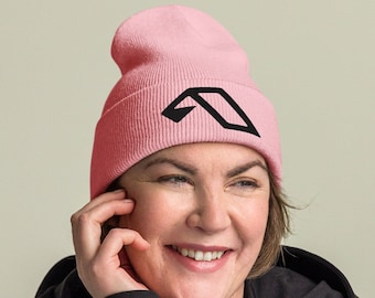 May include: A light pink beanie with a black geometric design. The beanie is made of a soft material and is designed to keep the head warm. The beanie is a stylish accessory for cold weather.