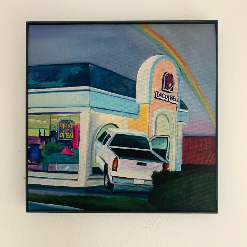 May include: A painting of a Taco Bell restaurant at night with a rainbow in the sky. A white pickup truck is pulling into the drive-thru lane. The sign says "Drive Thru Open".