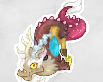 May include: A sticker featuring a cartoon dragon-like creature with a tan head, antlers, and a white beard. The creature has a brown body, a pink tail, and a blue flame on its chest. The sticker is on a white background.
