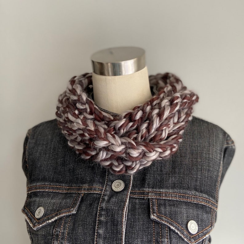This chunky brown and gray scarf necklace is made of many layers of crochet chains by designer DottieQ. Wear it gathered and sleek like an infinity scarf, or twisted for a layered chain look.