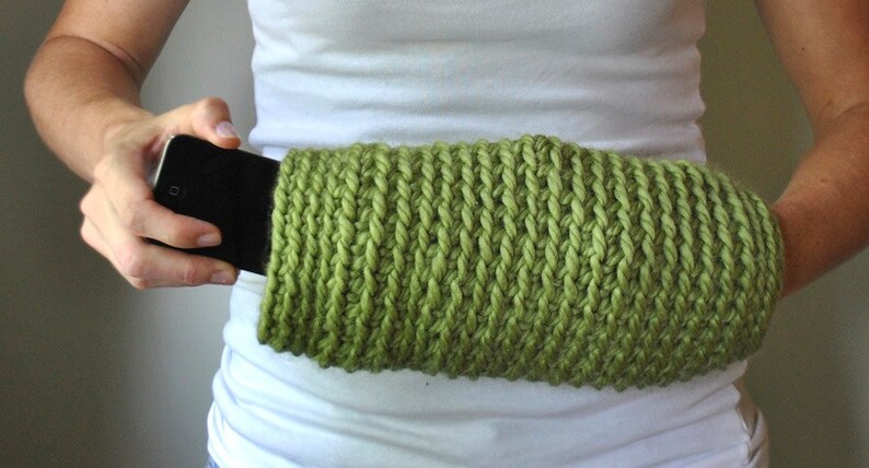 Snuggle up in this sleek crochet hand muff with an interior pocket perfect for a cell phone, keys or debit card. The Modern Muff is slim around the wrist openings with a larger middle area for hands.