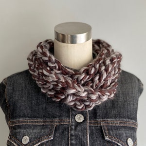 This chunky brown and gray scarf necklace is made of many layers of crochet chains by designer DottieQ. Wear it gathered and sleek like an infinity scarf, or twisted for a layered chain look.