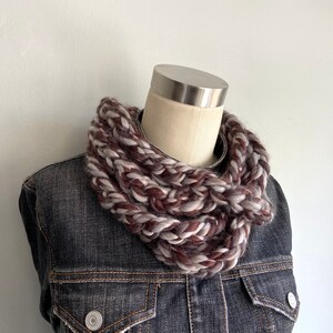 This chunky brown and gray scarf necklace is made of many layers of crochet chains by designer DottieQ. Wear it gathered and sleek like an infinity scarf, or twisted for a layered chain look.