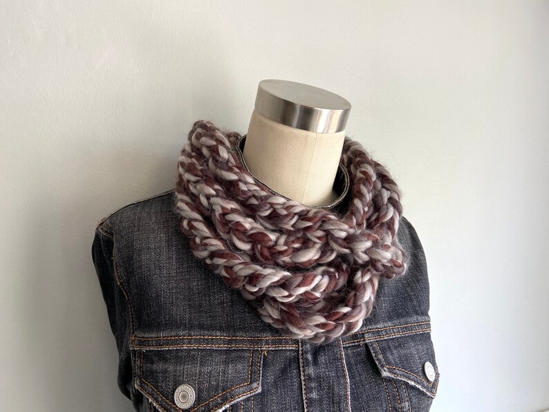 This chunky brown and gray scarf necklace is made of many layers of crochet chains by designer DottieQ. Wear it gathered and sleek like an infinity scarf, or twisted for a layered chain look.