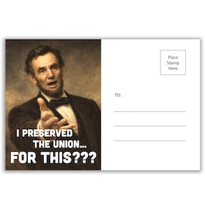 May include: A postcard featuring a portrait of Abraham Lincoln with the text "I PRESERVED THE UNION... FOR THIS???" on the front. The back of the postcard is blank with lines for the recipient's address and a stamp placement.