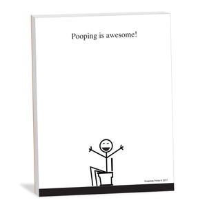 May include: A white notepad with the text "Pooping is awesome!" printed in black at the top. A stick figure drawing of a person sitting on a toilet with their arms raised in the air is at the bottom of the notepad.