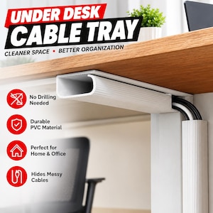 May include: A white under desk cable tray made of PVC material, featuring a ribbed texture. The tray is mounted beneath a wooden desk surface, concealing black and white electrical cables that run through the channel and down a desk leg.