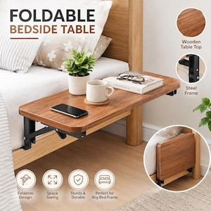May include: A foldable bedside table with a wood-grain surface and a black steel frame. The table is attached to a bed frame and features a flat top surface, a folding mechanism, and a compact design that allows it to be folded down against the bed.