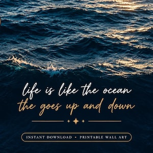 May include: A digital download printable wall art featuring a dark blue ocean wave background with sunlight reflecting on the water. The text reads: life is like the ocean the goes up and down, with a gold star icon and horizontal lines below.