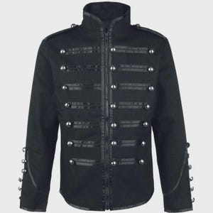 May include: A black military-style jacket featuring a high collar, a central zipper closure, and horizontal black braided trim across the chest. The jacket is adorned with rows of silver-toned metallic buttons on the front and on the cuffs.