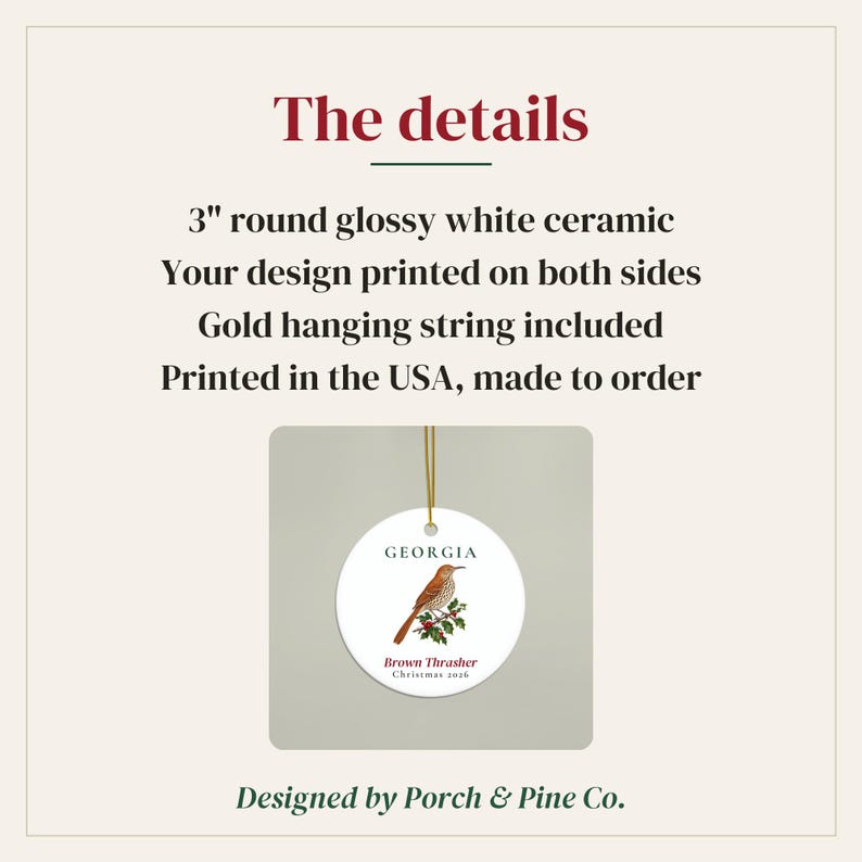 May include: A 7.62 cm round glossy white ceramic ornament featuring a brown thrasher bird illustration on a branch with red berries. The text reads Georgia, Brown Thrasher, and Christmas 2026. A gold hanging string is attached to the top of the ornament.