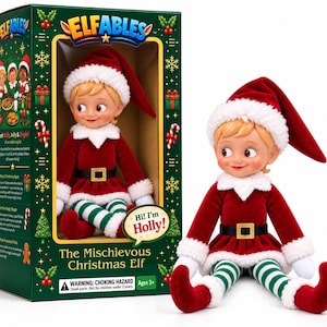 May include: A plush Christmas elf doll named Holly with blonde hair, wearing a red velvet outfit with white faux fur trim, a black belt with a gold buckle, and green and white striped leggings, displayed next to its green cardboard packaging box.