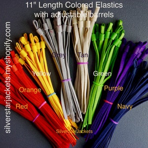 May include: Assortment of 11-inch long elastic bands in various colors, including red, orange, yellow, grey, tan, green, purple, and navy. The elastic bands have adjustable barrels.